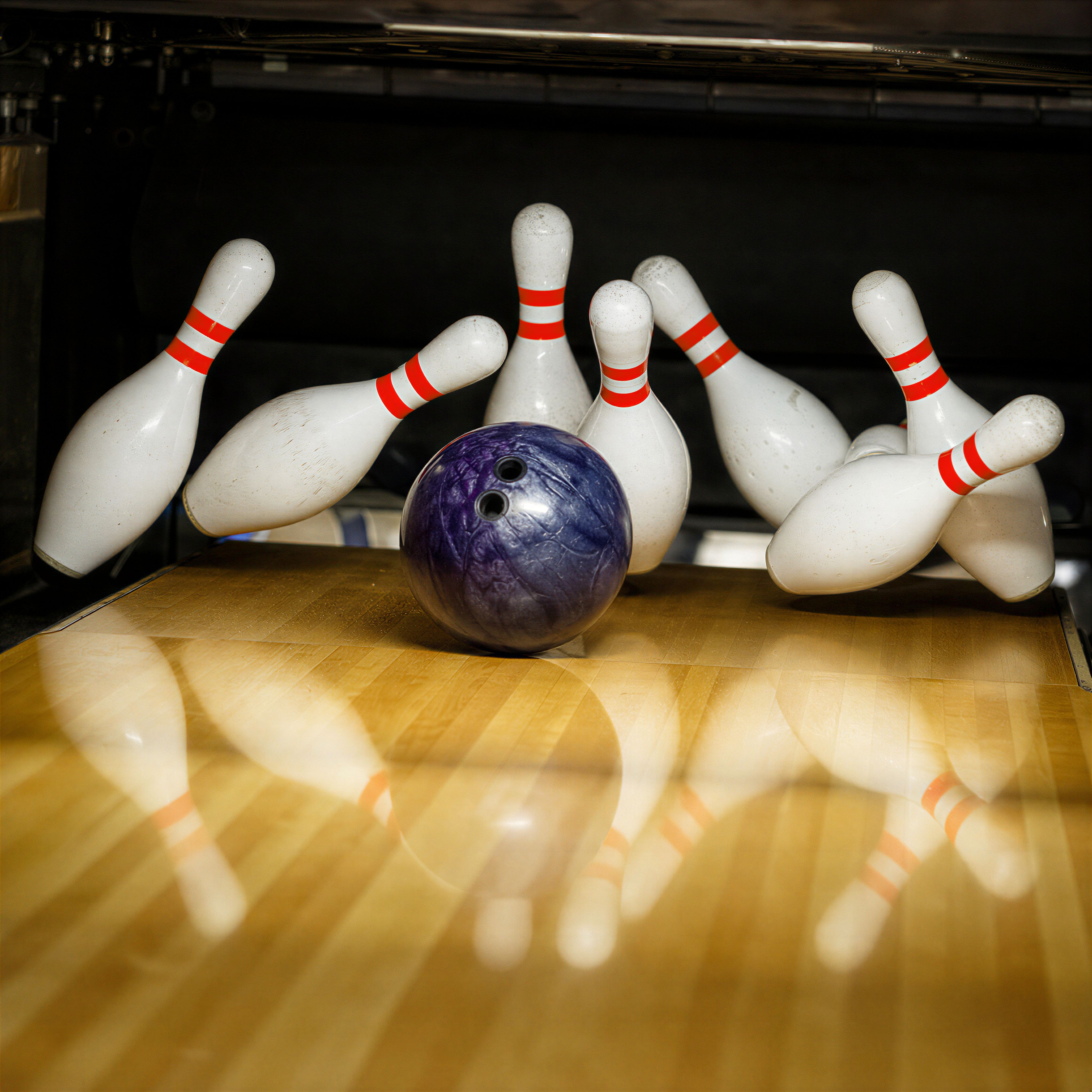 Bowling ball striking pins